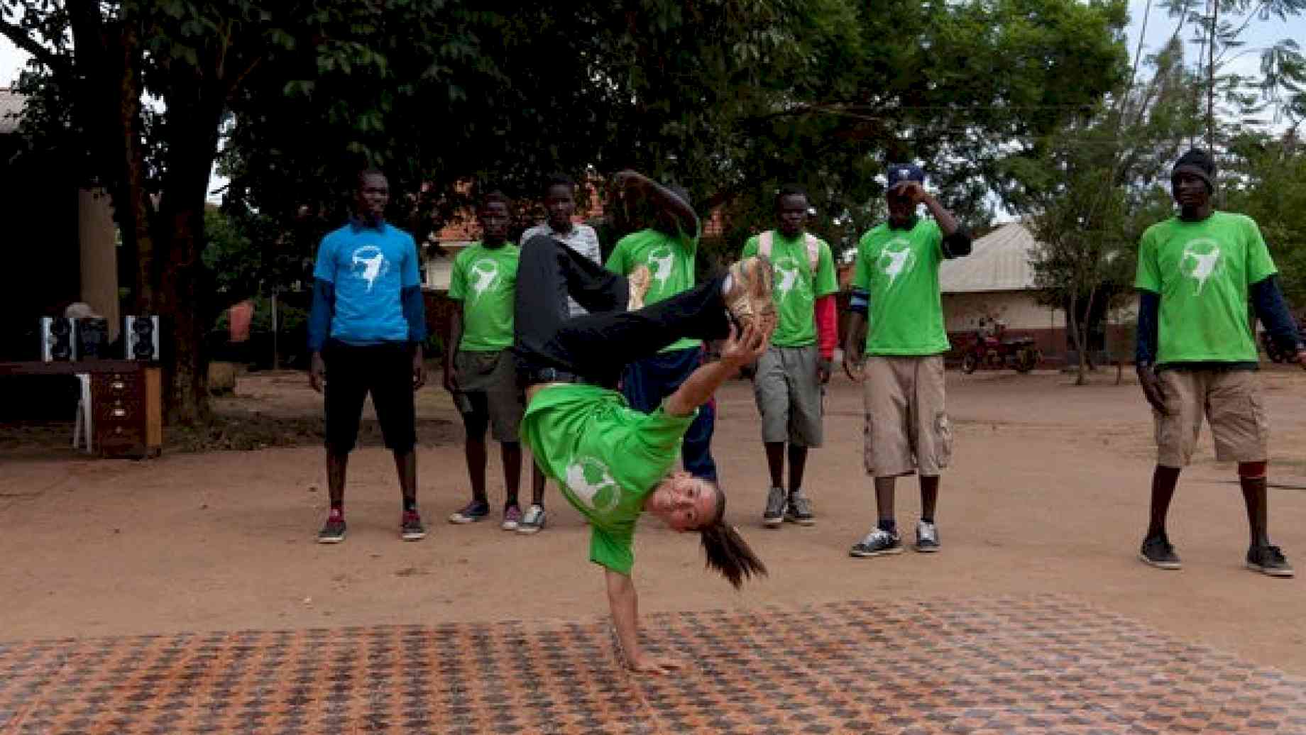 A Peace Corps volunteer in Uganda works with a breakdancing group of girls in her community.