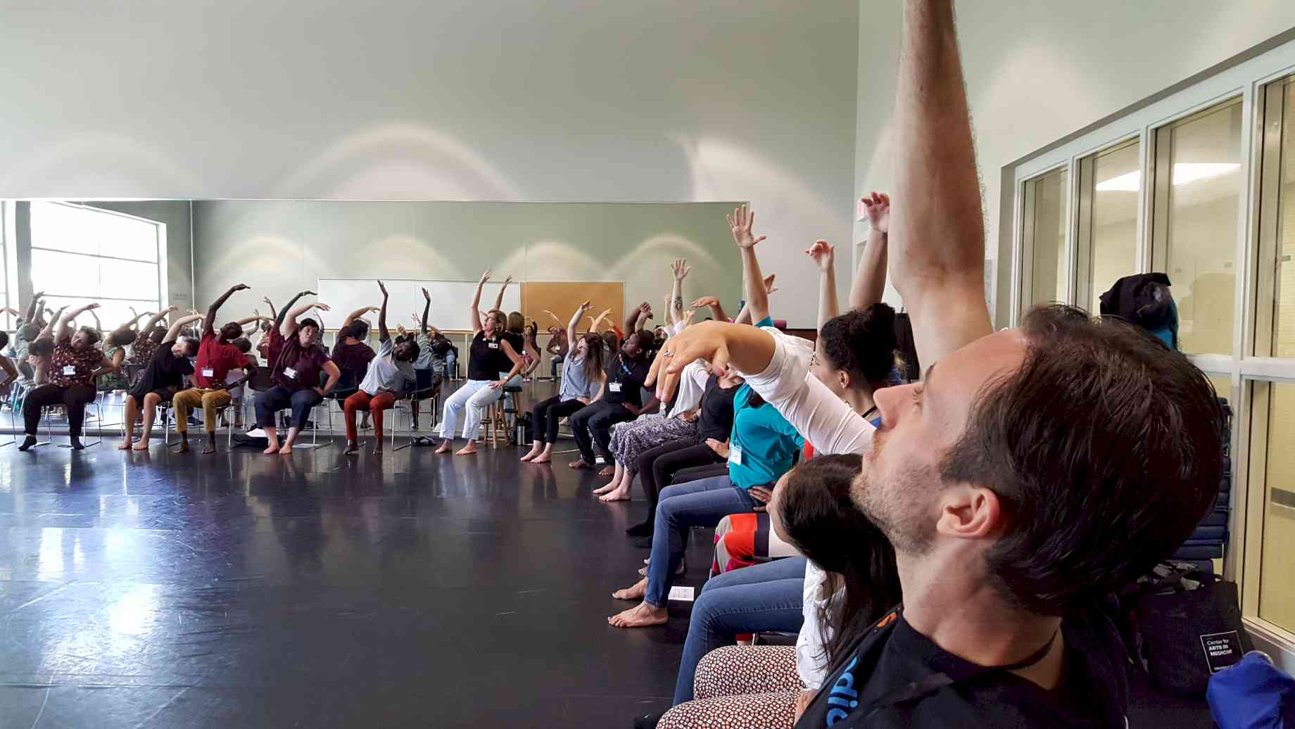 Our participants explore mindful movement with chair-based dancing for those with mobility differences.